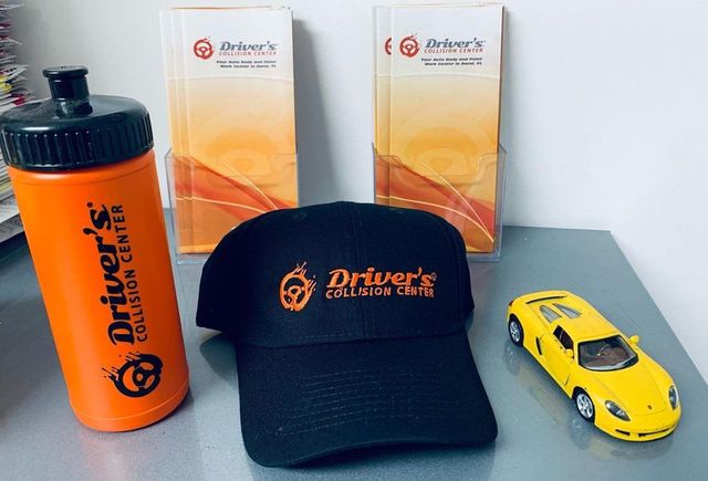 Driver's Collision Center cap, bottle and brochures