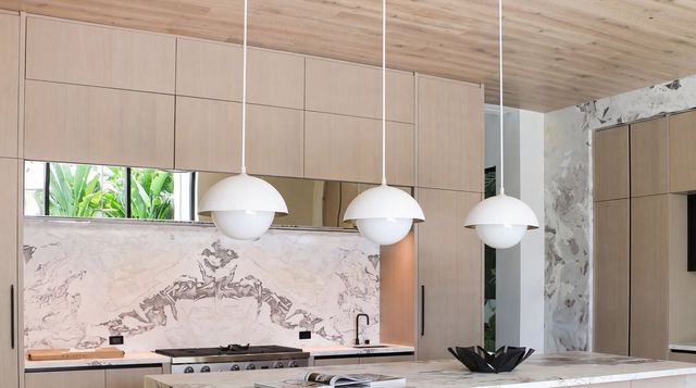 Kitchen with marble backsplash and range